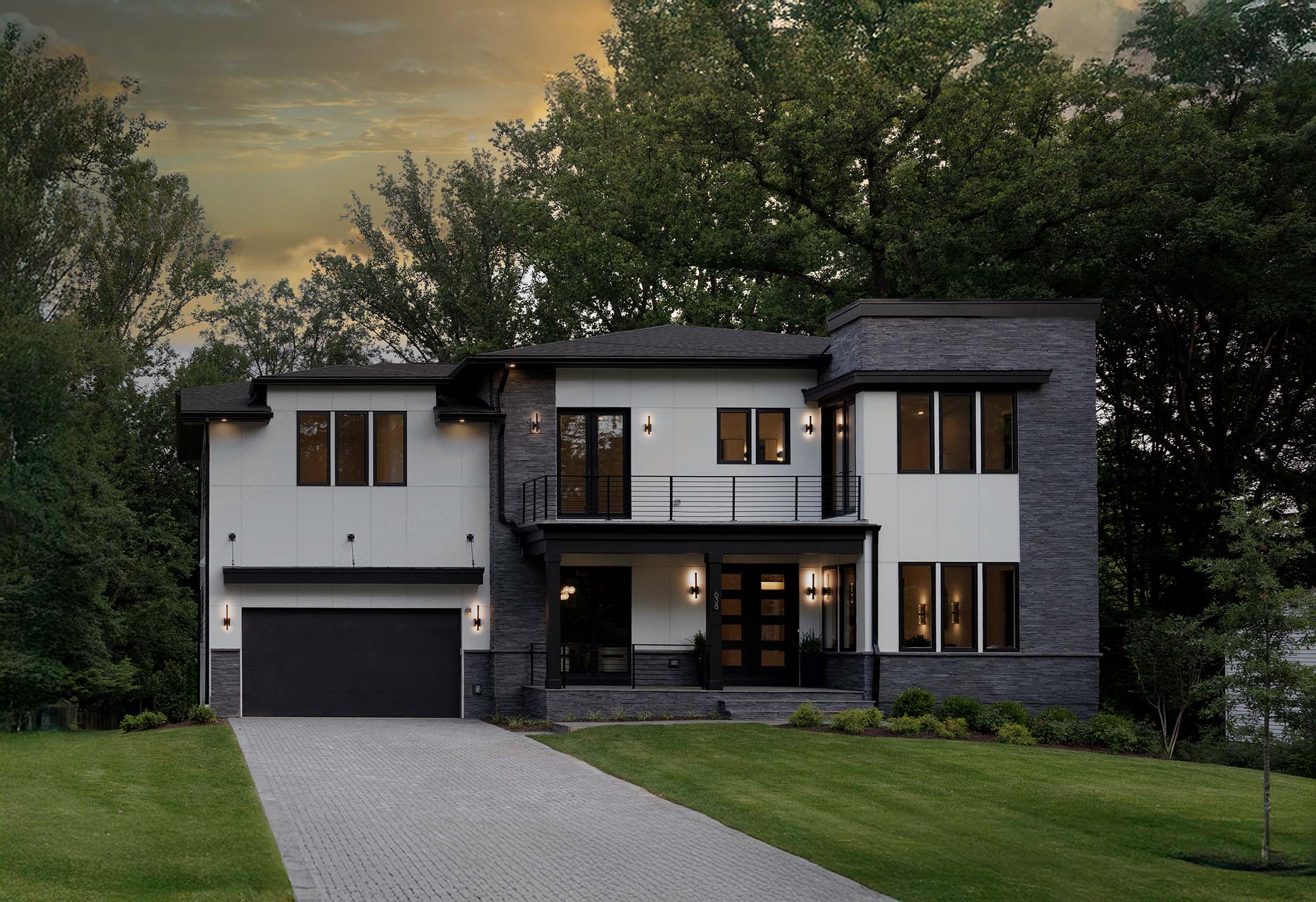 Luxury modern residential architecture with stone masonry exterior and dusk lighting captured by architectural photographer near me